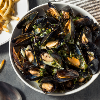 Steamed Mussels prepared in garlic butter.