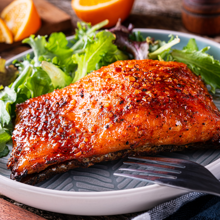 Wild-Caught Sockeye Salmon prepared on a plate with lettuce. 