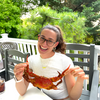 Girl holding huge blue crab and smiling big